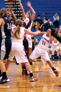 Senior Michelle Madrigal attempts to score for the Lady Lions while senior Dreya Williams and sophomore 