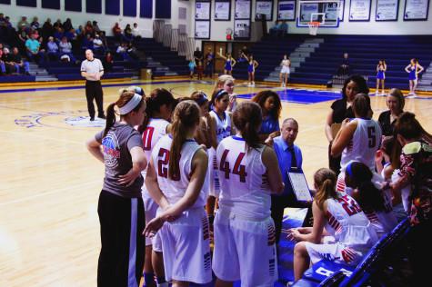 Coach Lamb huddles the team together during a timeout.